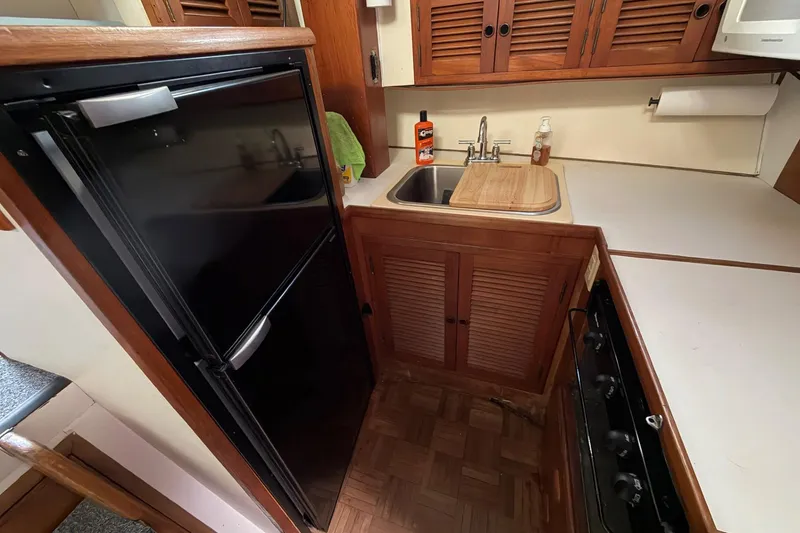 Slide: The Image of Compact kitchen in 1984 Golden Star 38 Trawler with fridge, sink, and stove. - 32