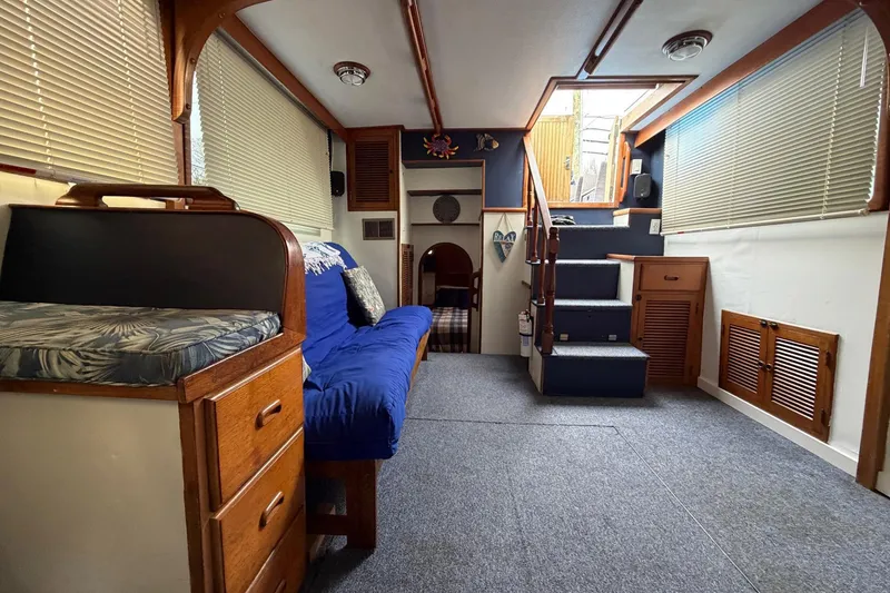 Slide: The Image of Interior of 1984 Golden Star 38 Trawler with cozy seating and wooden accents. - 36