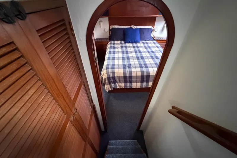 Slide: The Image of Cozy cabin interior of 1984 Golden Star 38 Trawler with plaid bedding and wooden accents. - 37