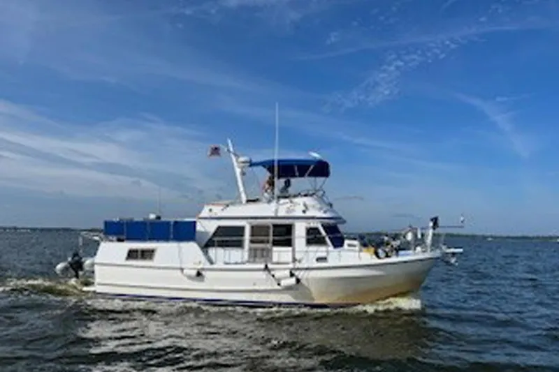 Slide: The Image of 1984 Golden Star 38 Trawler cruising on open water under a clear blue sky. - 4