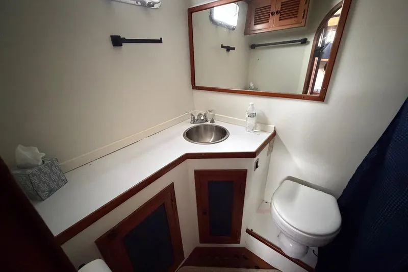 Slide: The Image of Bathroom interior of 1984 Golden Star 38 Trawler with sink, mirror, and toilet. - 41