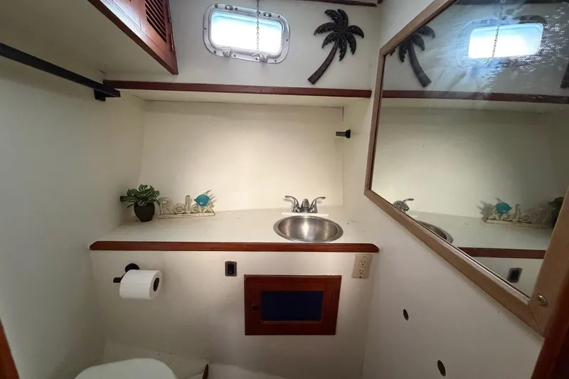 Slide: The Image of Bathroom interior of 1984 Golden Star 38 Trawler with sink, mirror, and decor. - 44