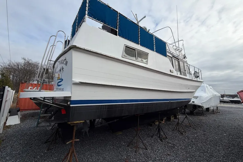 Slide: The Image of 1984 Golden Star 38 Trawler on stands, with blue accents and covered windows. - 6