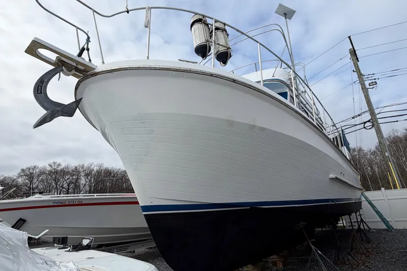 Slide: The Image of 1984 Golden Star 38 Trawler on dry dock, showcasing its hull and anchor. - 8