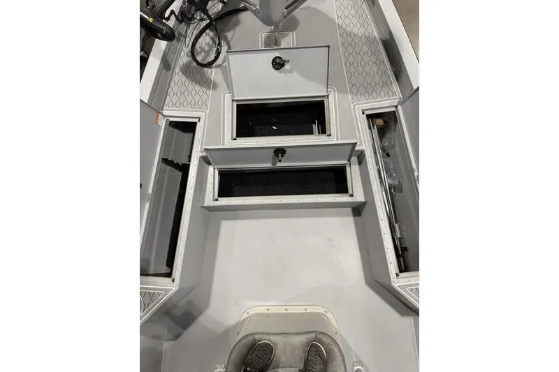 Slide: The Image of 2026 G3 Bay 22 GX boat interior with open storage compartments and seating. - 3