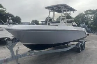 Slide: The Image of 2023 Bayliner Trophy T22CC boat on trailer, parked outdoors. - 3