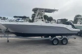 Slide: The Image of 2023 Bayliner Trophy T22CC boat on trailer, side view, outdoors. - 4