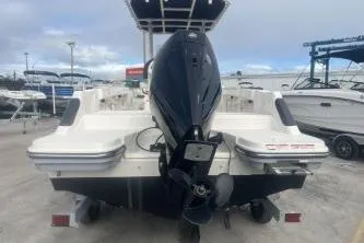Slide: The Image of 2023 Bayliner Trophy T22CC boat with outboard motor, docked at a marina. - 5