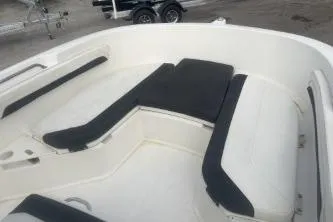 Slide: The Image of 2023 Bayliner Trophy T22CC boat interior with cushioned seating and sleek design. - 9