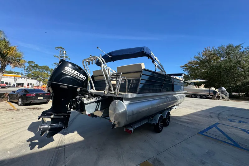 Slide: The Image of 2022 Crest Classic LX 240 SLRC pontoon boat with Suzuki outboard motor on trailer. - 13
