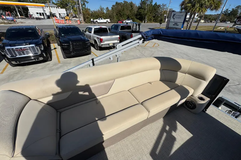 Slide: The Image of 2022 Crest Classic LX 240 SLRC boat interior with beige seating and cup holders. - 22