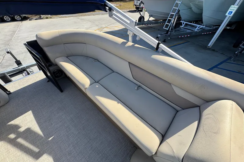 Slide: The Image of 2022 Crest Classic LX 240 SLRC boat interior with beige seating and carpet flooring. - 23