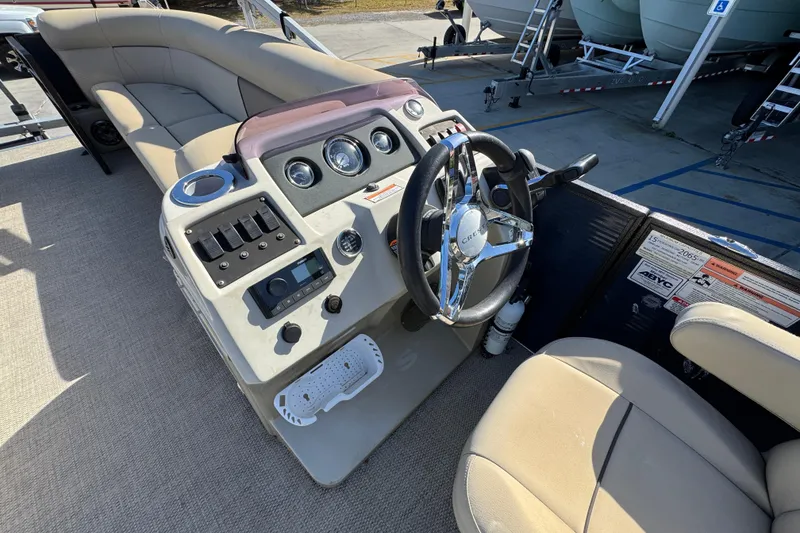 Slide: The Image of 2022 Crest Classic LX 240 SLRC boat interior with steering wheel and control panel. - 27