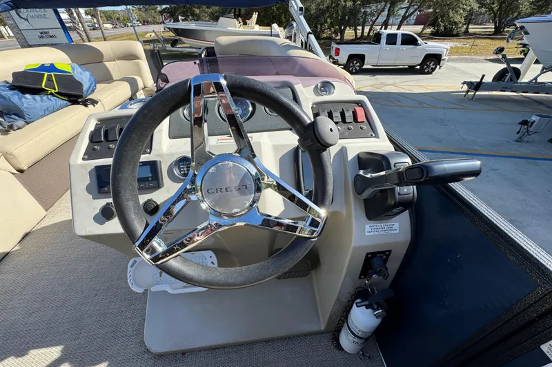 Slide: The Image of Steering console of 2022 Crest Classic LX 240 SLRC boat with chrome accents. - 28