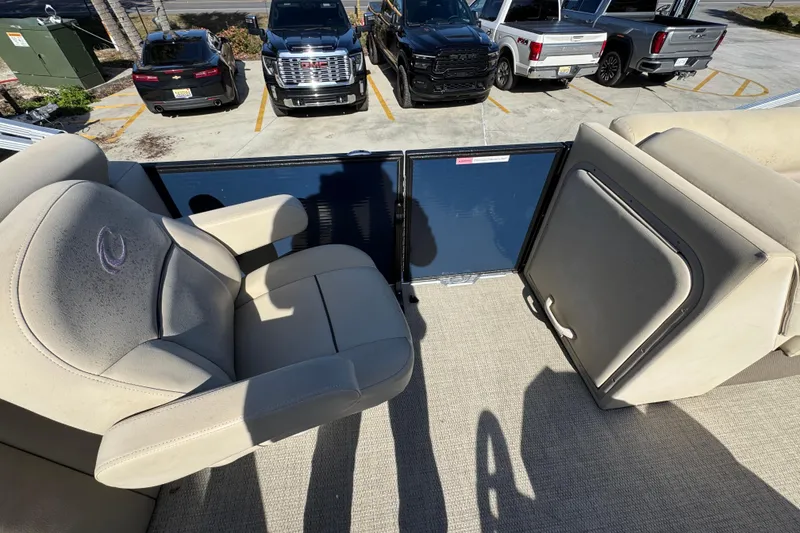 Slide: The Image of 2022 Crest Classic LX 240 SLRC boat interior with beige seating and storage compartment. - 30