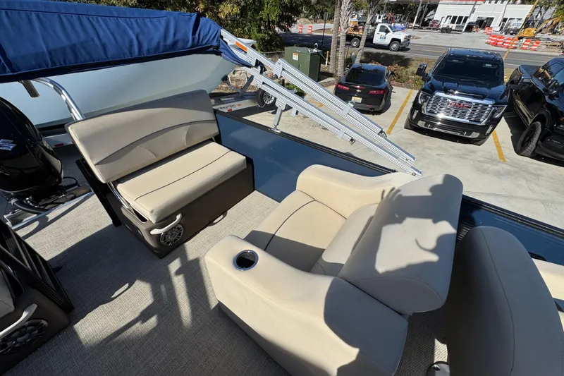 Slide: The Image of 2022 Crest Classic LX 240 SLRC boat interior with beige seating and cup holder. - 34