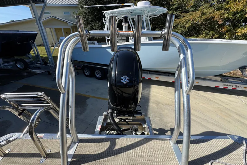 Slide: The Image of 2022 Crest Classic LX 240 SLRC boat with Suzuki outboard motor in a marina. - 36