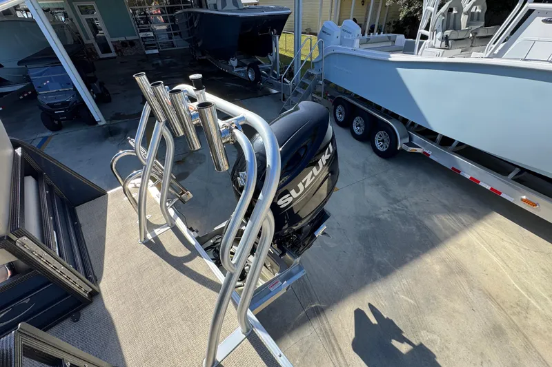 Slide: The Image of 2022 Crest Classic LX 240 SLRC with Suzuki outboard motor in a boatyard. - 37
