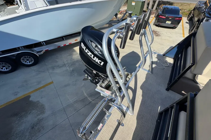 Slide: The Image of 2022 Crest Classic LX 240 SLRC with Suzuki outboard motor, docked on trailer. - 38