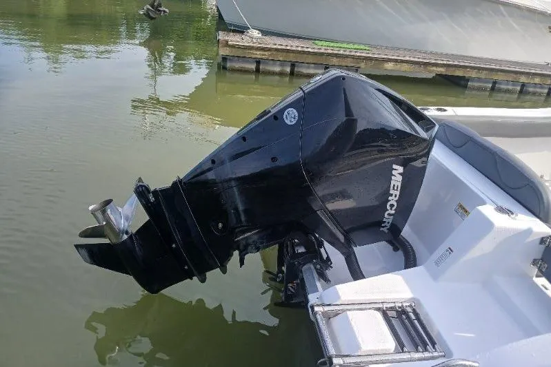 Slide: The Image of 2024 NauticStar 222L Offshore boat with Mercury outboard motor at dock. - 8