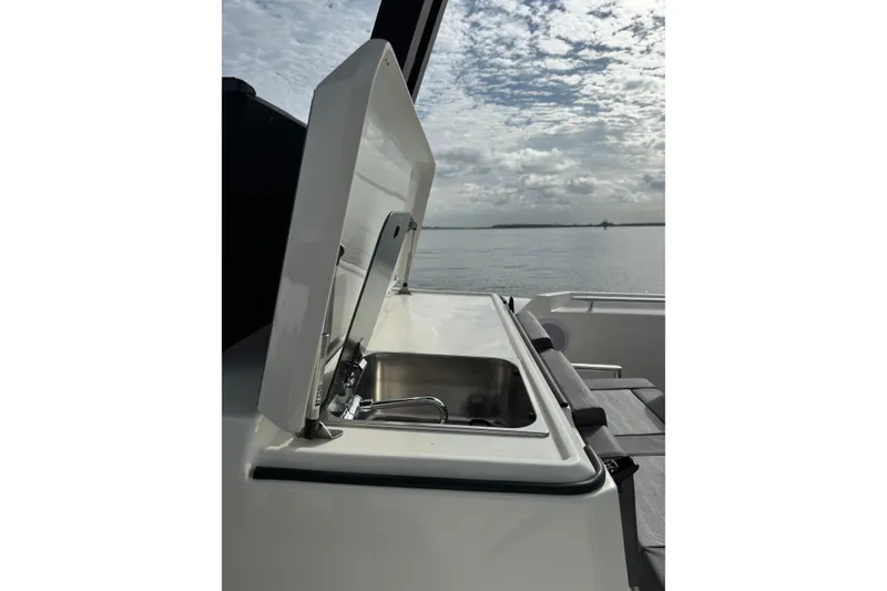 Slide: The Image of 2026 Northstar ORION 10 boat with open sink, ocean view, and cloudy sky. - 14