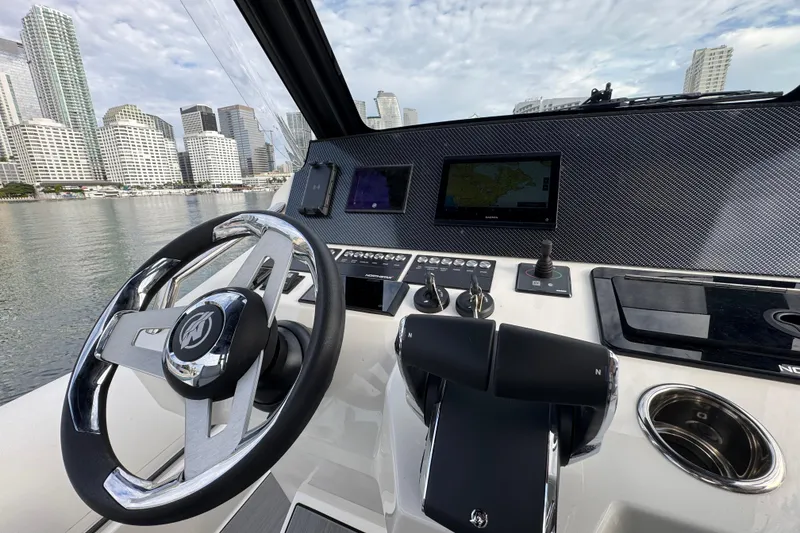 Slide: The Image of Helm of Northstar ORION 10 boat, 2026 model, with city skyline in background. - 19