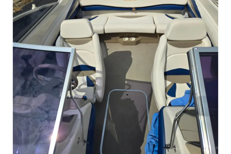 Slide: The Image of 2001 Glastron GX 205 boat interior with beige seating and blue accents. - 18