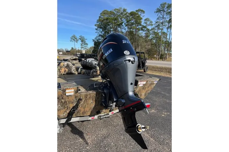 Slide: The Image of 2026 G3 Sportsman 1710 PFX Camo boat with Yamaha outboard motor in a parking lot. - 5