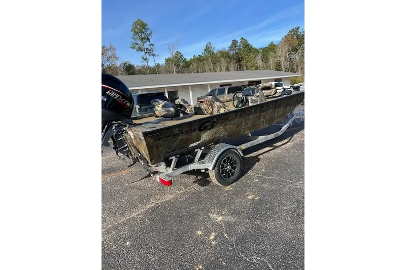 Slide: The Image of 2026 G3 Sportsman 1710 PFX Camo boat on trailer, parked outdoors. - 6