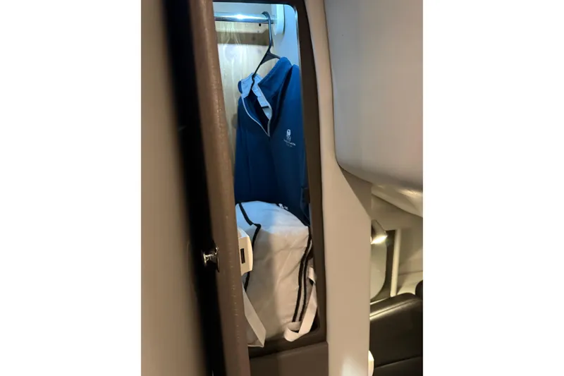 Slide: The Image of 2018 Formula 400 Super Sport cabin closet with blue jacket and white bag. - 11