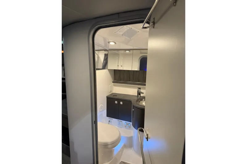 Slide: The Image of 2018 Formula 400 Super Sport boat bathroom interior with modern fixtures and lighting. - 12