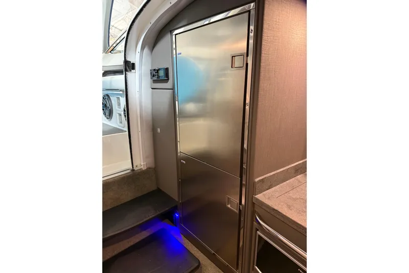 Slide: The Image of 2018 Formula 400 Super Sport yacht interior with stainless steel refrigerator and modern design. - 14