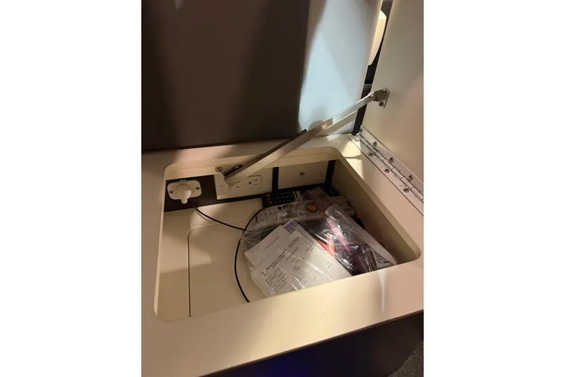 Slide: The Image of Storage compartment with electrical outlets in a 2018 Formula 400 Super Sport boat. - 26