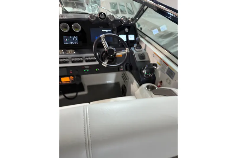 Slide: The Image of 2018 Formula 400 Super Sport boat cockpit with modern controls and steering wheel. - 7