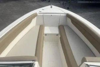 Slide: The Image of 2022 Scout 210 Dorado boat interior with beige and white seating. - 10