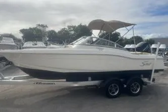 Slide: The Image of 2022 Scout 210 Dorado boat on trailer, side view, with canopy. - 3