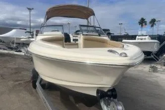 Slide: The Image of 2022 Scout 210 Dorado boat on trailer, beige exterior, parked outdoors. - 5