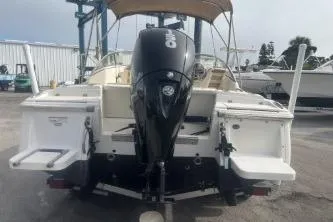 Slide: The Image of 2022 Scout 210 Dorado boat with outboard motor, docked at marina. - 6