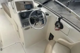 Slide: The Image of 2022 Scout 210 Dorado boat interior with steering wheel and control panel. - 8