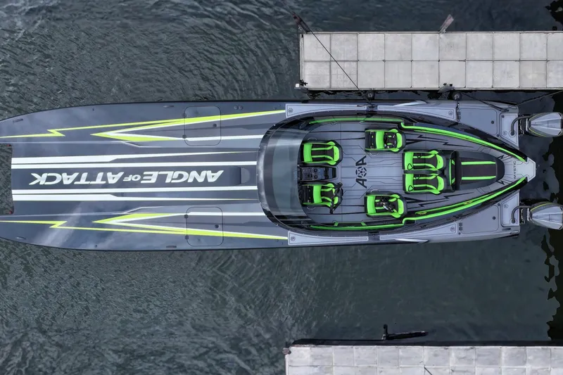 The Image of Aerial view of 2025 Mystic Powerboats C4000, docked, with sleek design and vibrant green accents. - 0