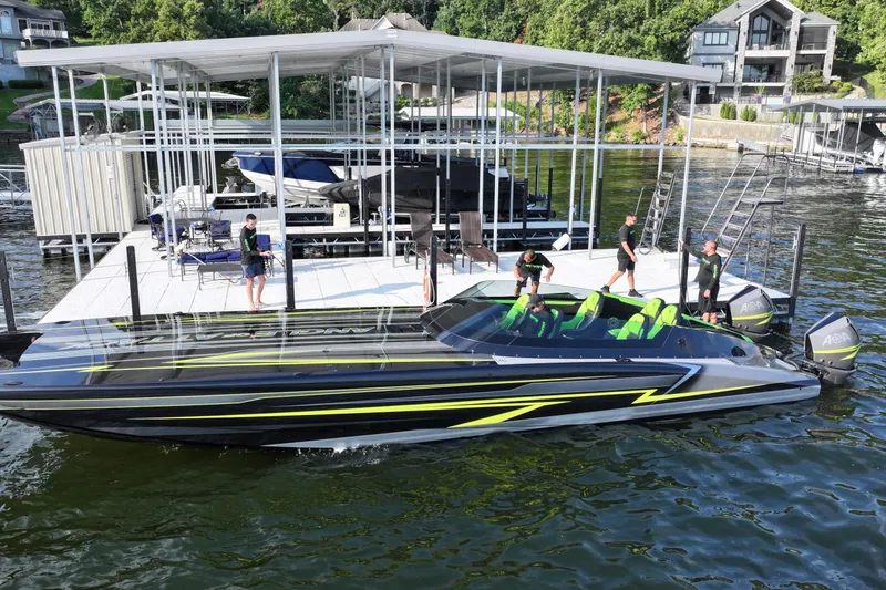Slide: The Image of 2025 Mystic Powerboats C4000 docked, featuring sleek design and vibrant green seating. - 10