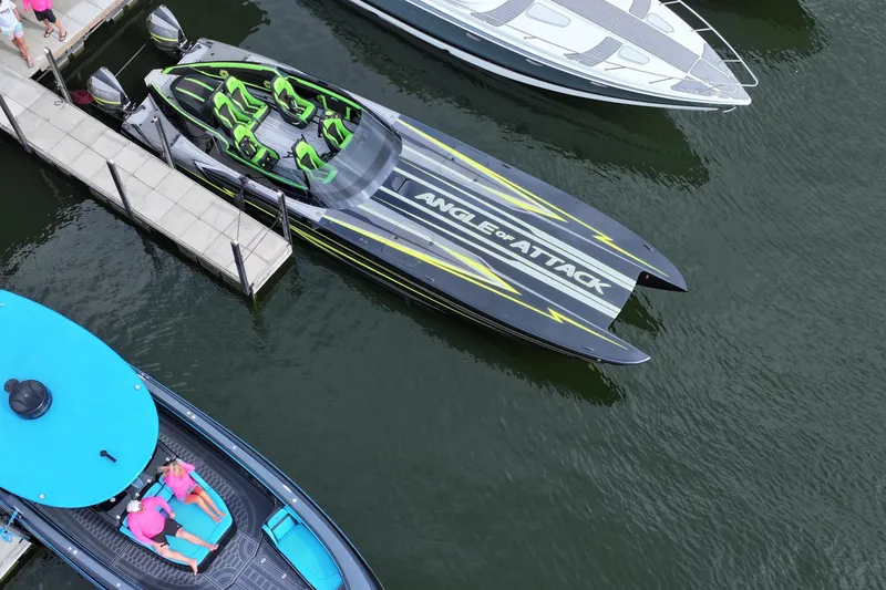 Slide: The Image of 2025 Mystic Powerboats C4000 docked, featuring sleek design and vibrant green seating. - 11