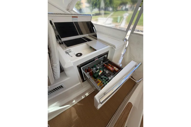 Slide: The Image of 2013 Tiara Yachts 3600 Coronet with open beverage cooler and grill on deck. - 10
