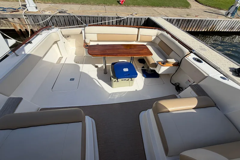 Slide: The Image of 2013 Tiara Yachts 3600 Coronet cockpit with seating, table, and cooler. - 11