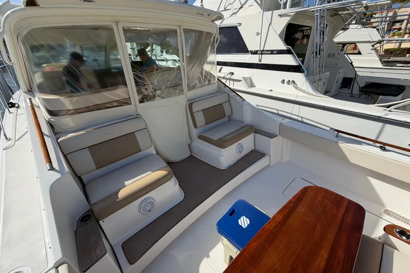 Slide: The Image of 2013 Tiara Yachts 3600 Coronet interior with seating and table, docked at marina. - 12