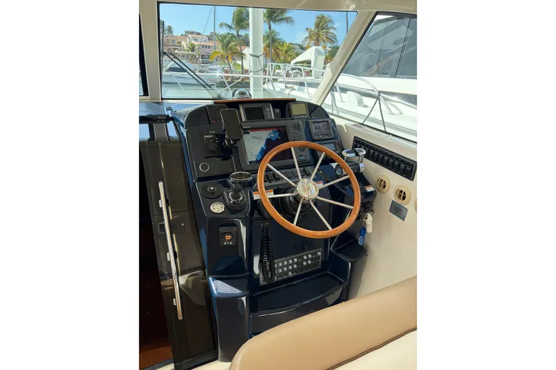 Slide: The Image of Helm of 2013 Tiara Yachts 3600 Coronet with navigation equipment and wooden steering wheel. - 14