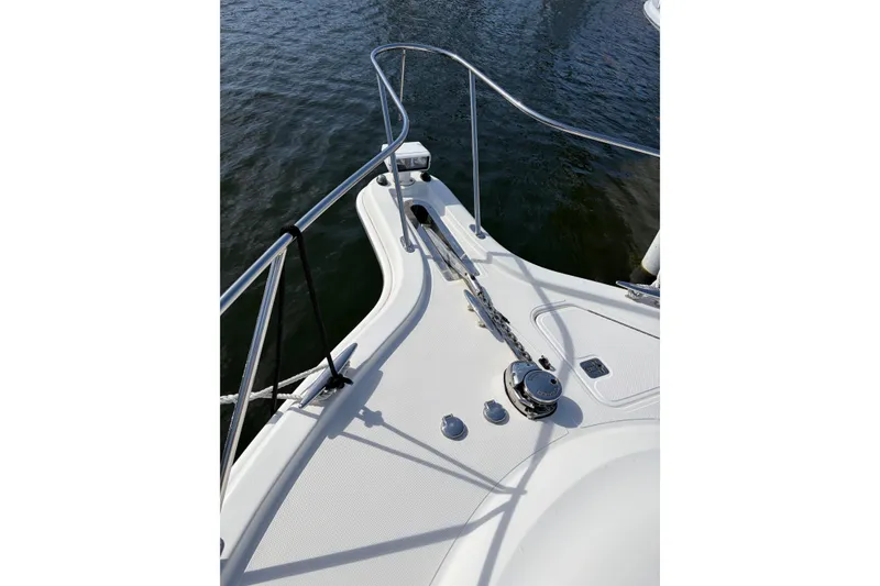 Slide: The Image of 2013 Tiara Yachts 3600 Coronet bow with anchor chain and railing on water. - 16