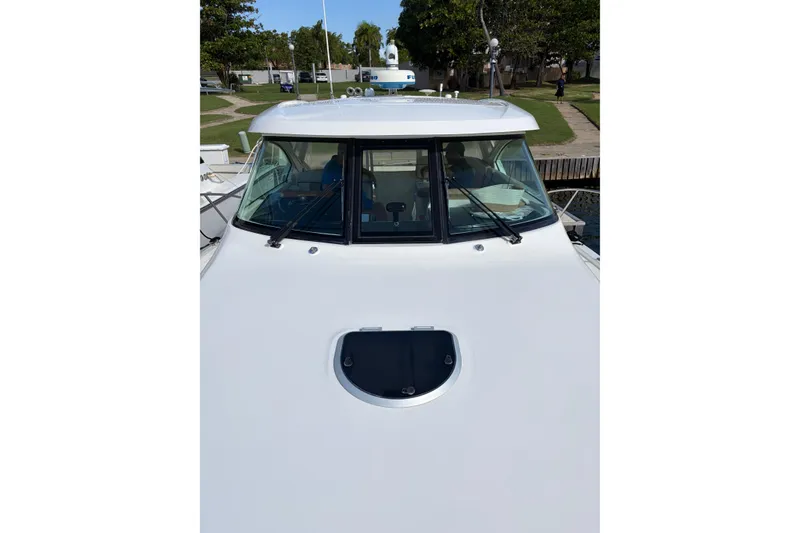 Slide: The Image of 2013 Tiara Yachts 3600 Coronet boat docked, front view with windshield and hatch. - 17