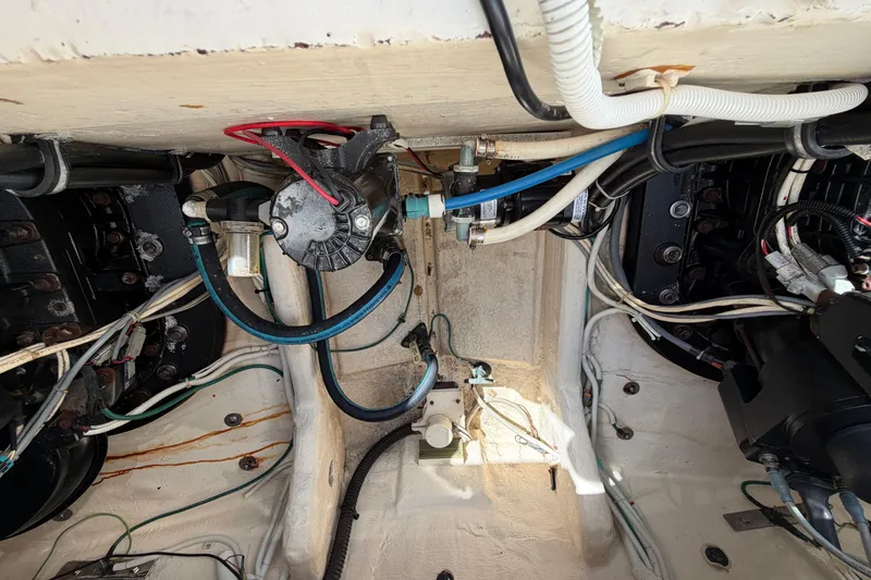 Slide: The Image of Engine compartment of a 2013 Tiara Yachts 3600 Coronet, showcasing wiring and mechanical components. - 24