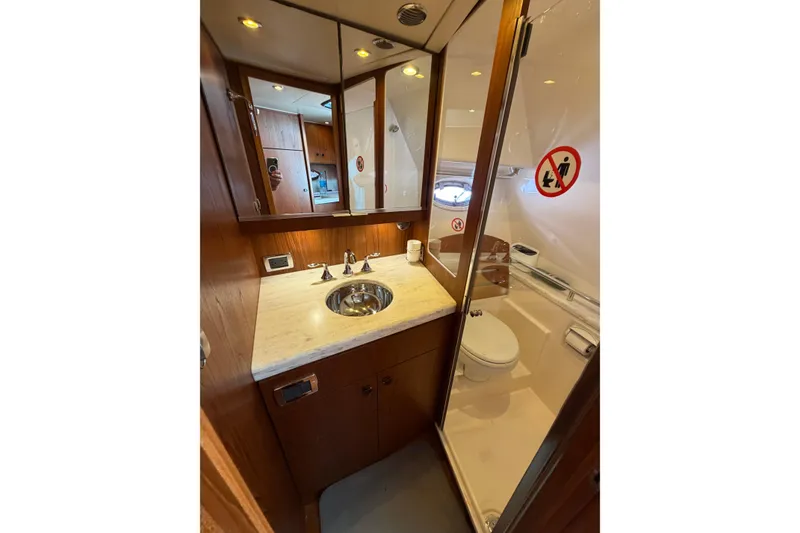 Slide: The Image of 2013 Tiara Yachts 3600 Coronet bathroom with sink, mirror, and toilet in compact space. - 3